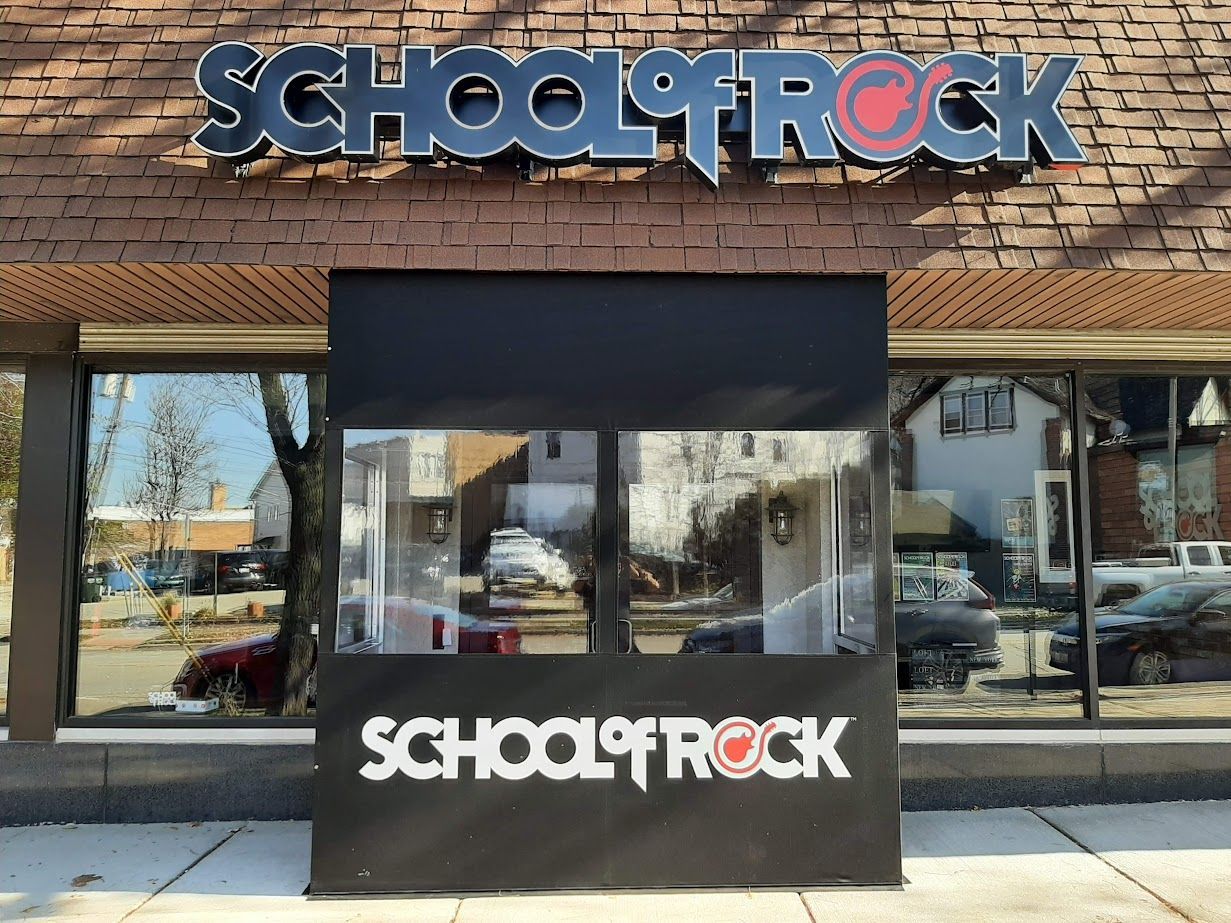 A brick building with a sign that says school rock