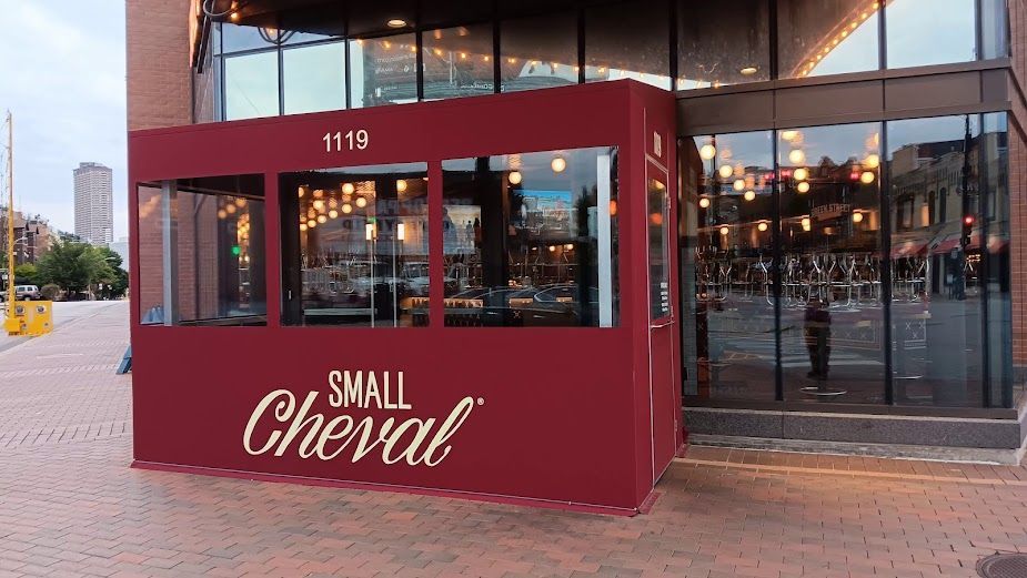 A small cheval restaurant is located on the side of a building.