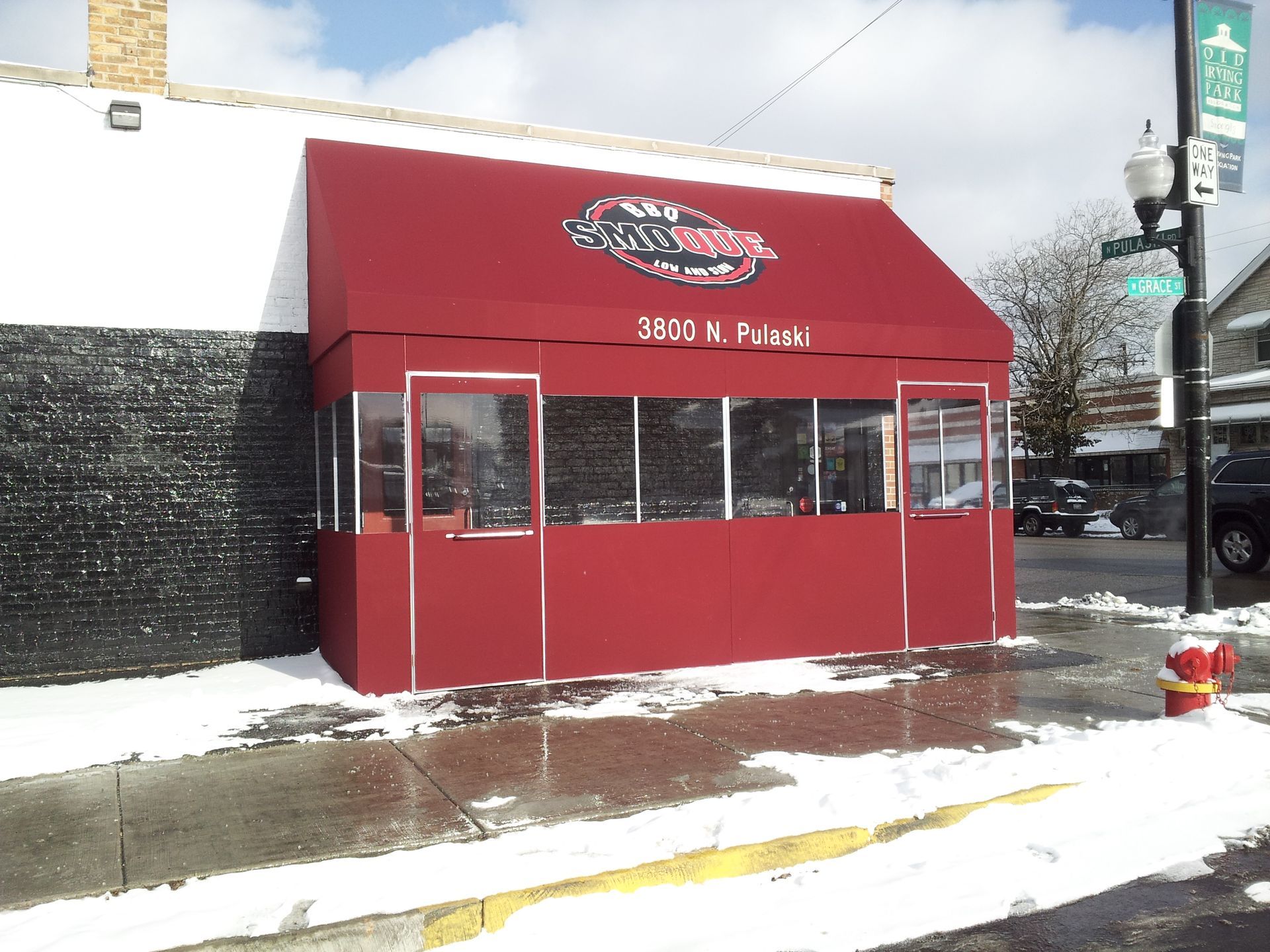 A building with a red awning that says ' 3402 n. adams ' on it