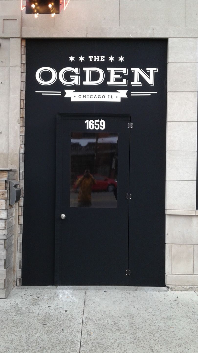 A black door with ogden written on it