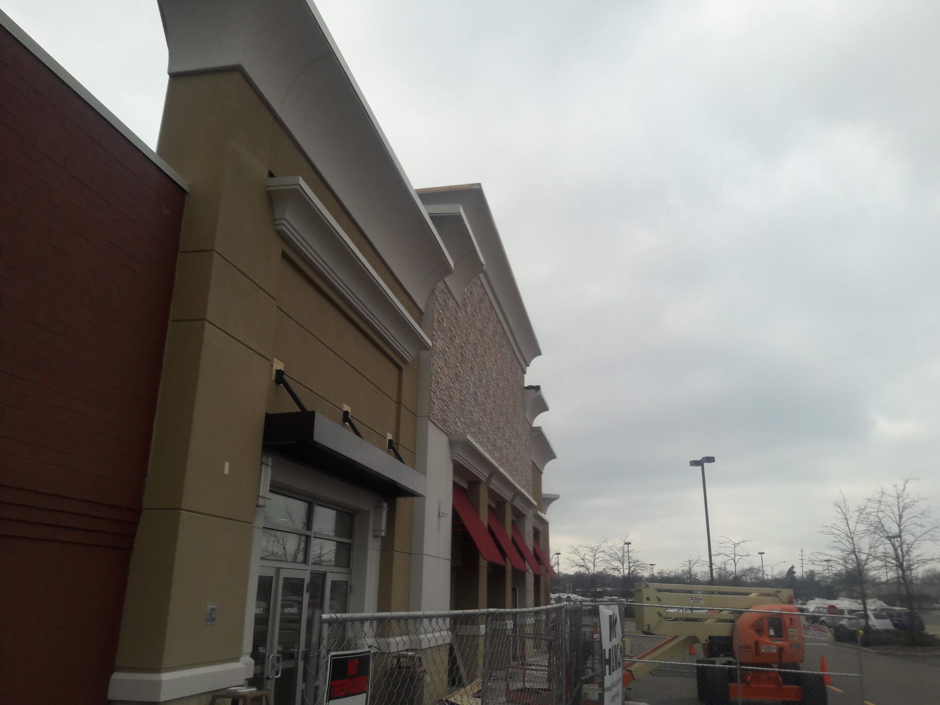 A large building under construction with a fence around it