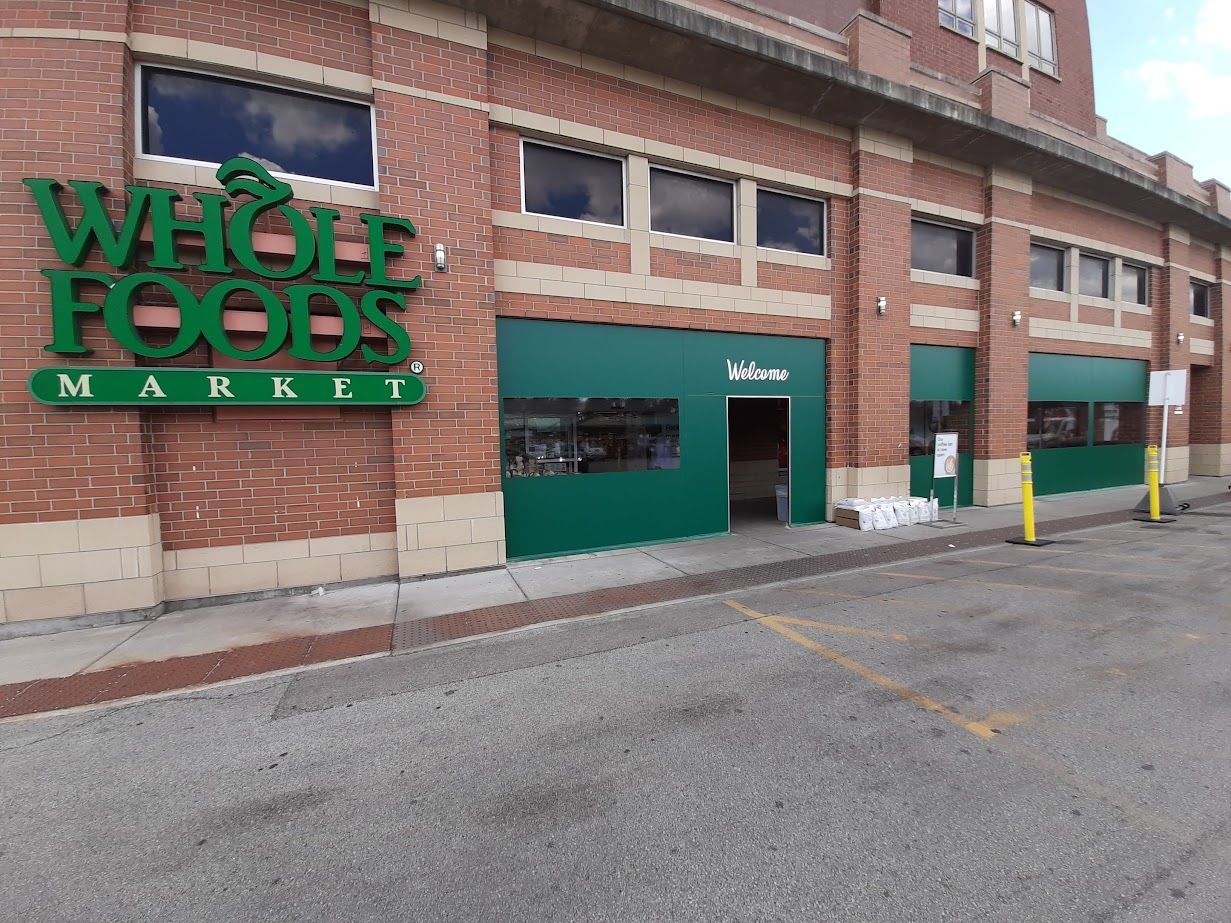 A whole foods market is located in a brick building