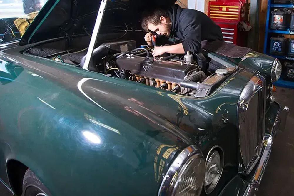 Mechanic Servicing A Green Car