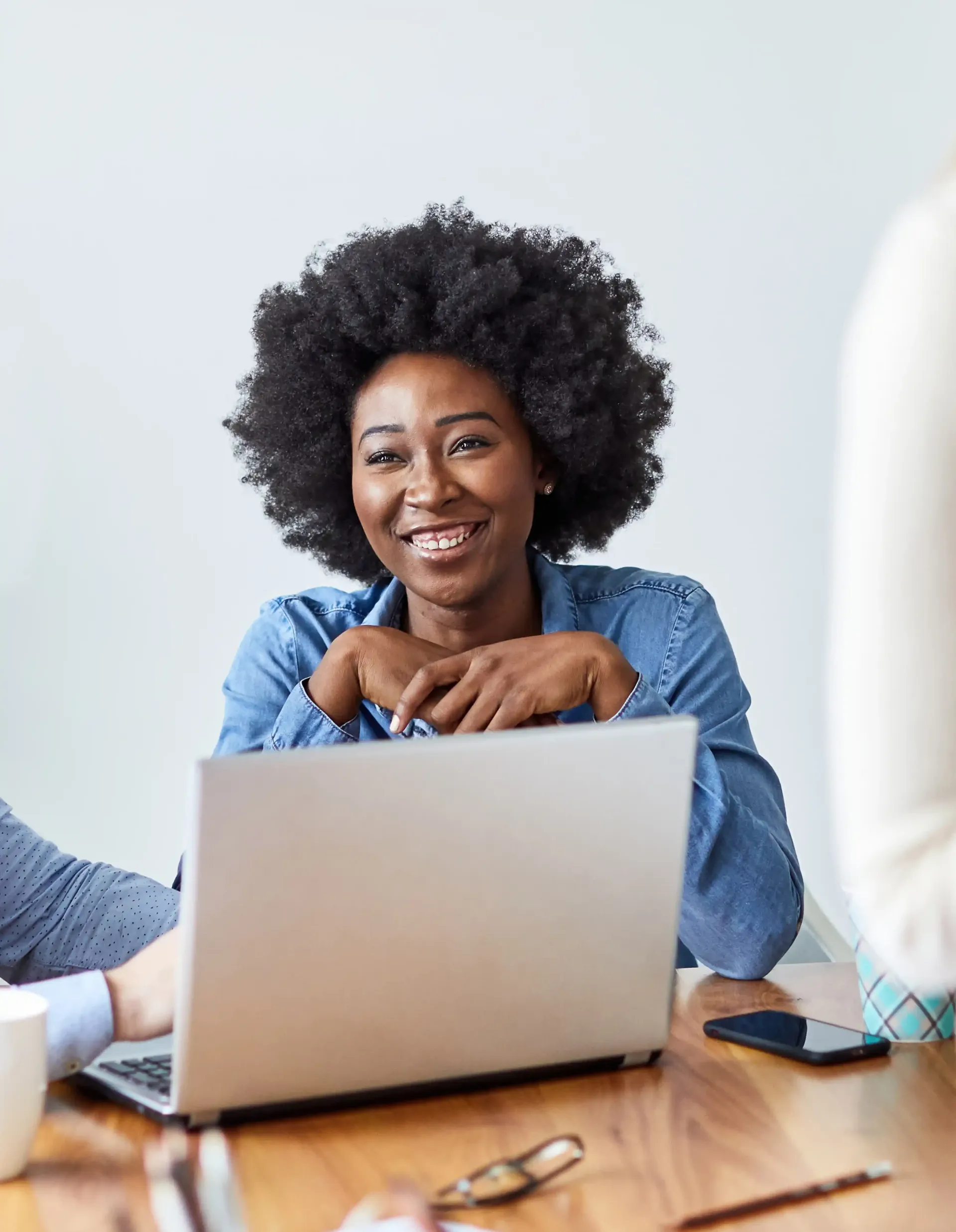 A woman is sitting at a table with a laptop computer to run a masterclass.