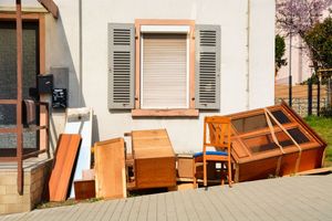 A house with a lot of furniture in front of it