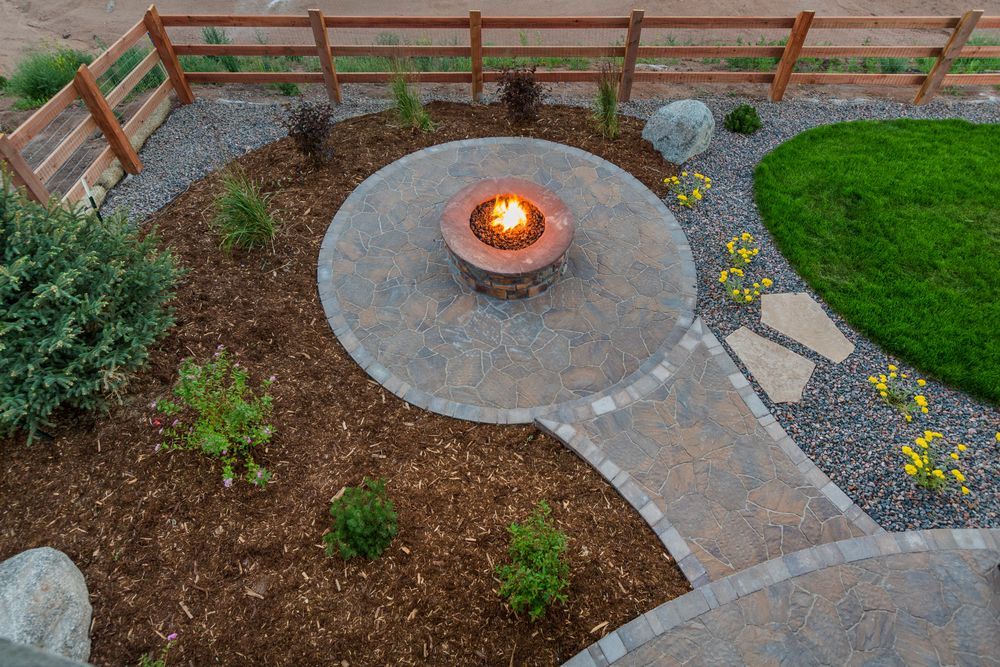 There is a fire pit in the middle of the yard.