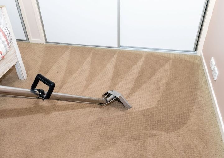 A vacuuming device cleaning carpet
