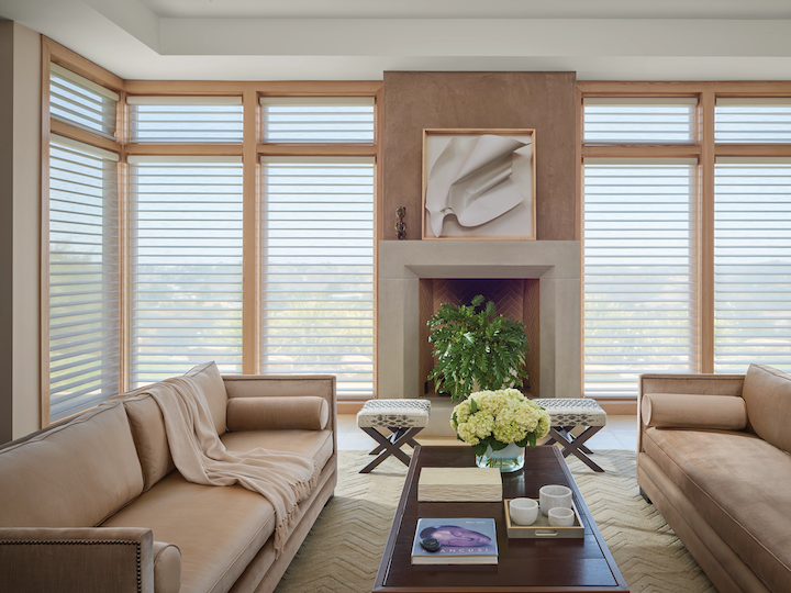 A living room with motorized window treatments