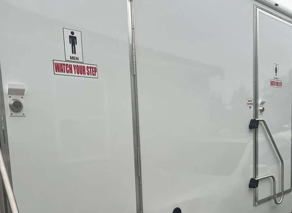 White portable restrooms, one with a 