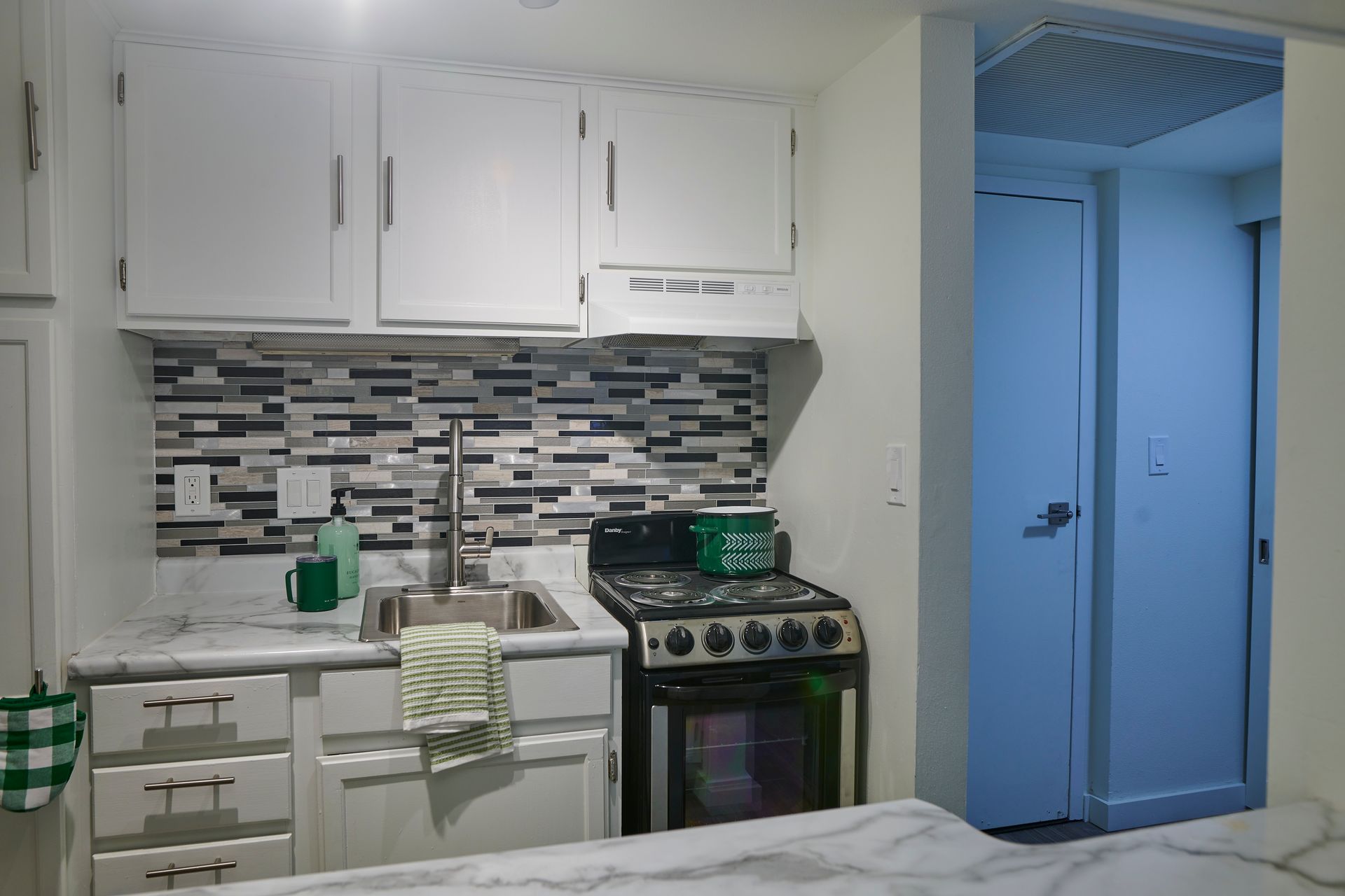 A small kitchen with a stove and a sink