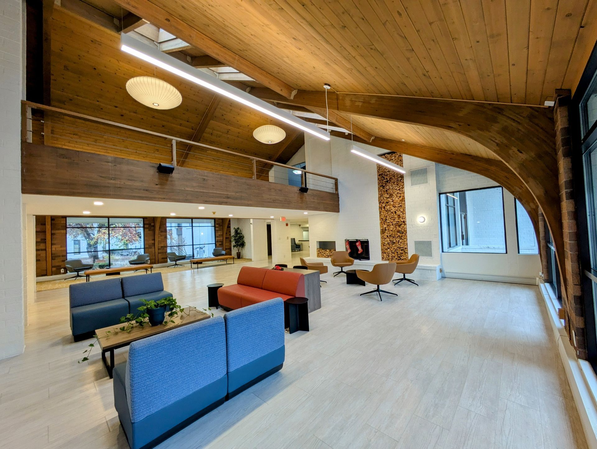 A large room with a lot of furniture and a wooden ceiling.