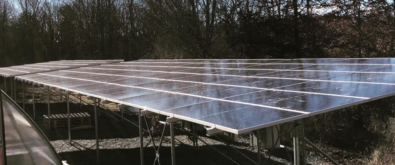 Photo of long grid of solar panels on a metal roof 