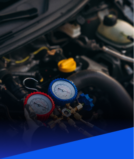 Automotive air conditioning manifold gauge set attached to an engine bay for maintenance and testing. | Heaven Sent Automotive