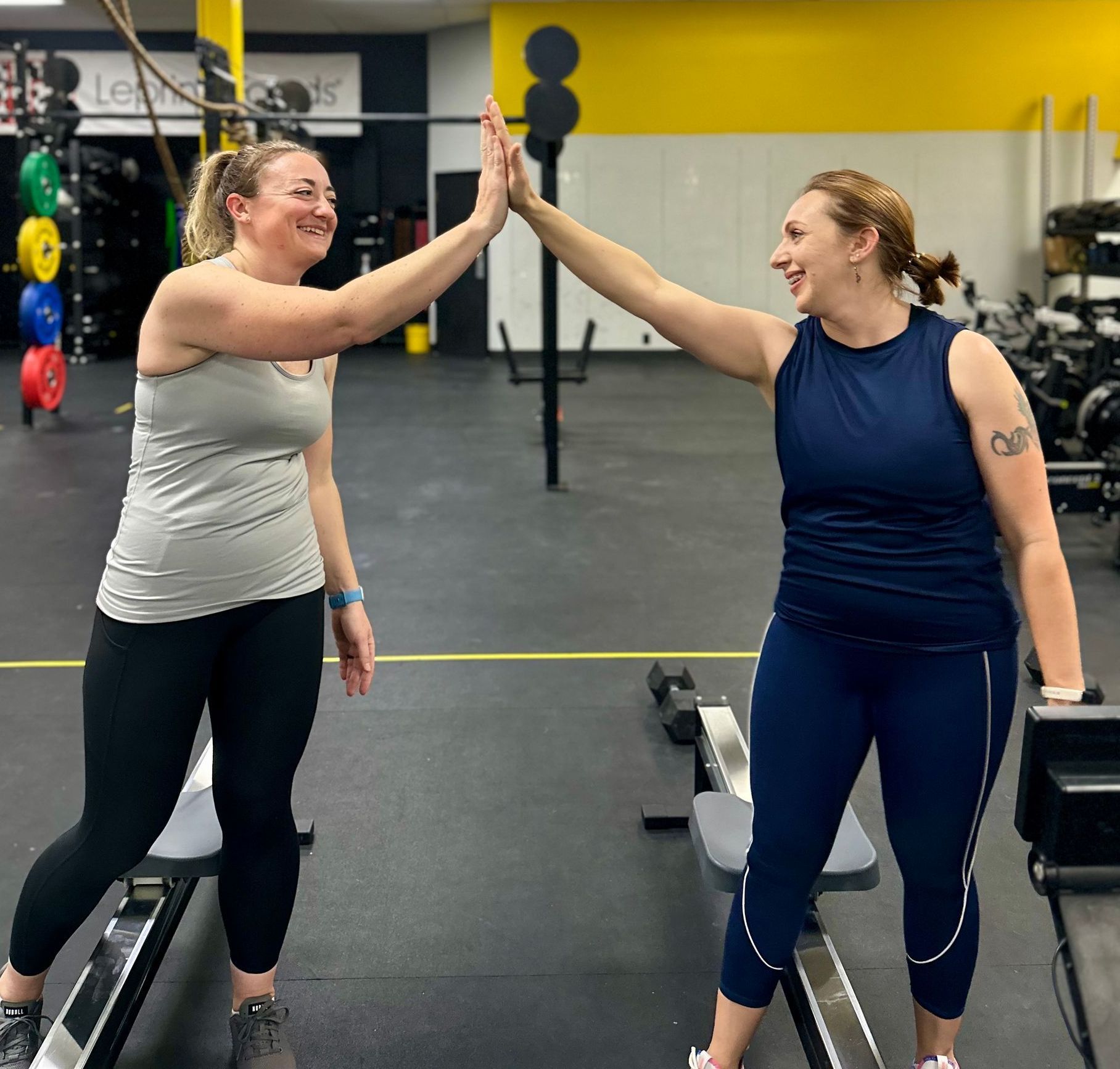 Teachers having a good time at gym working out together. 