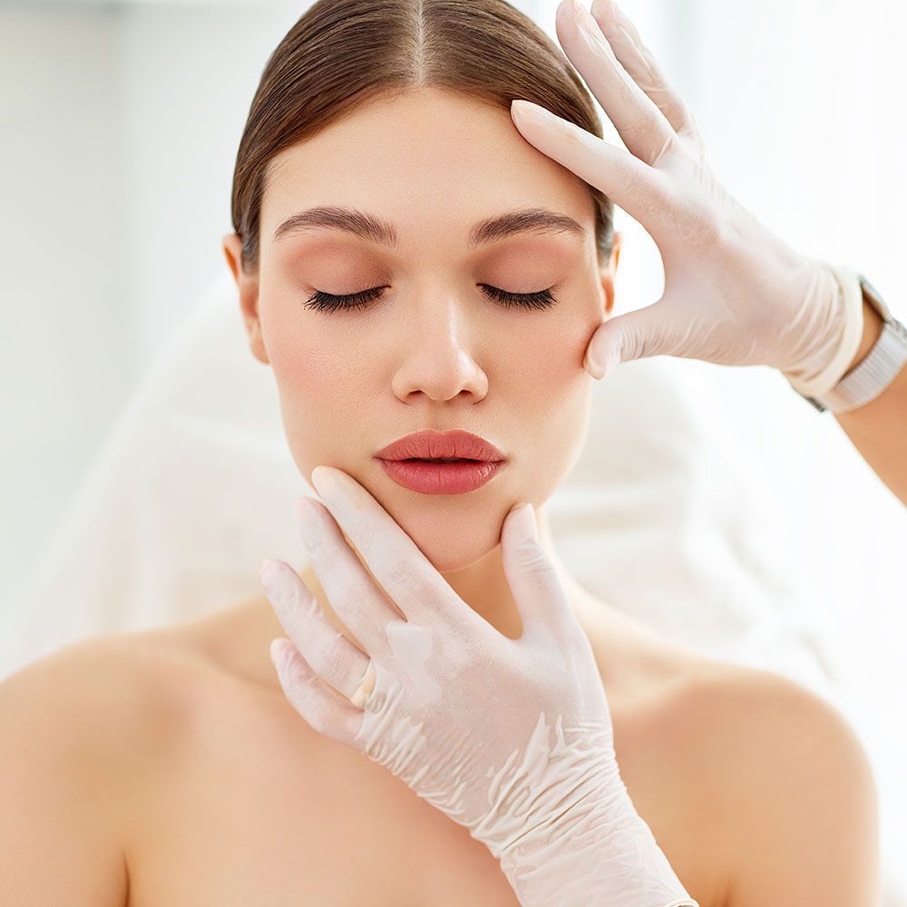 Doctor Checking the Woman's Face for Dermaplaning