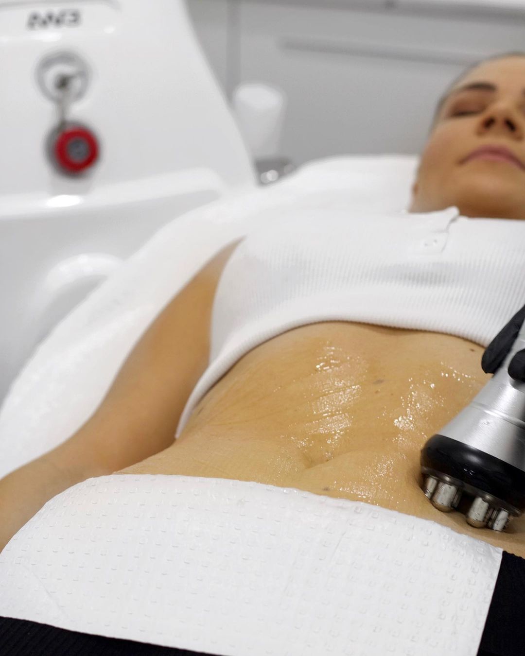 closeup of beautician doing laser epilation treatment on beautiful female body