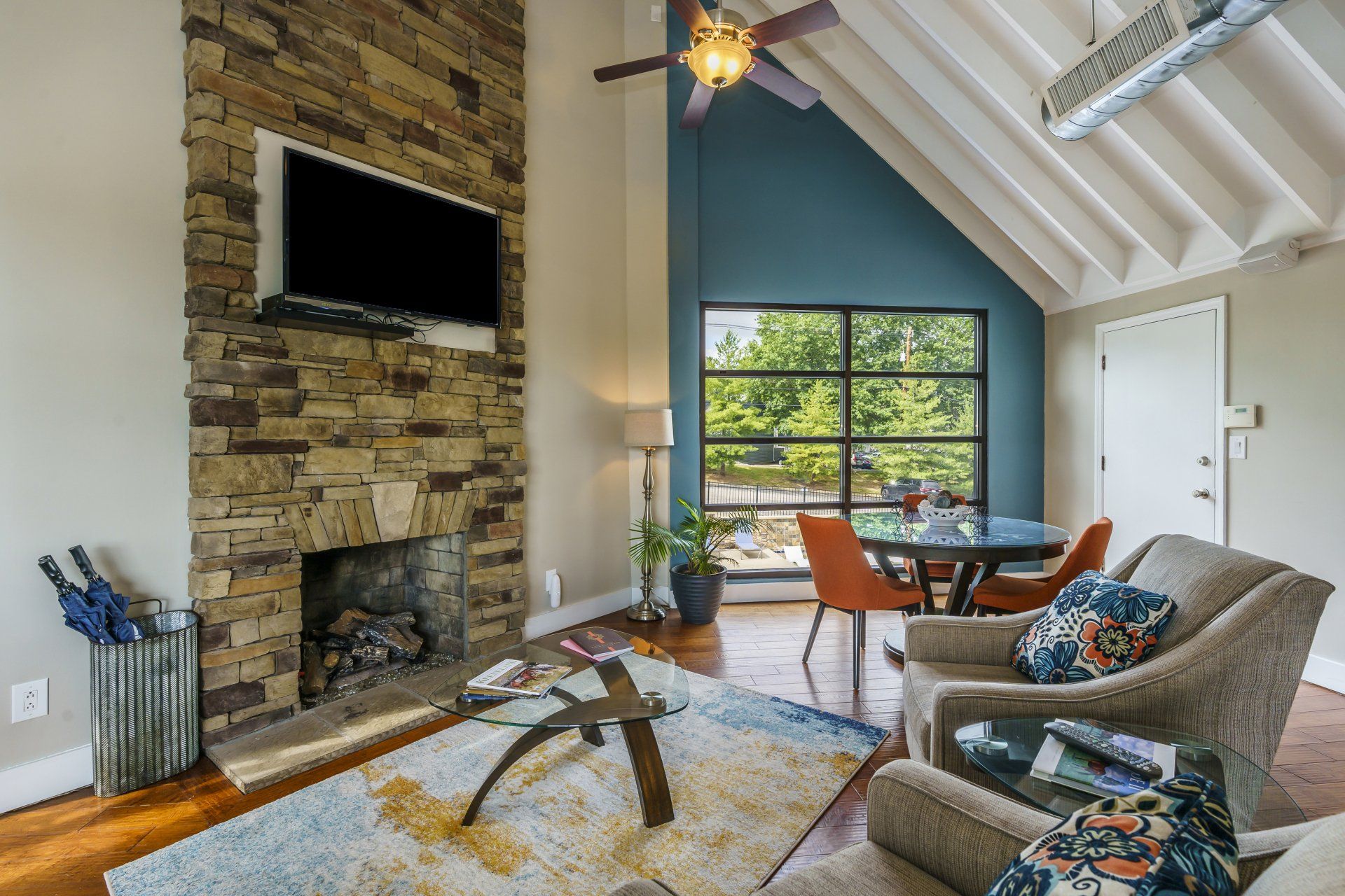 A living room with a fireplace and a flat screen tv
