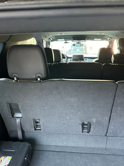 A man is shaking hands with a woman sitting in a limousine.