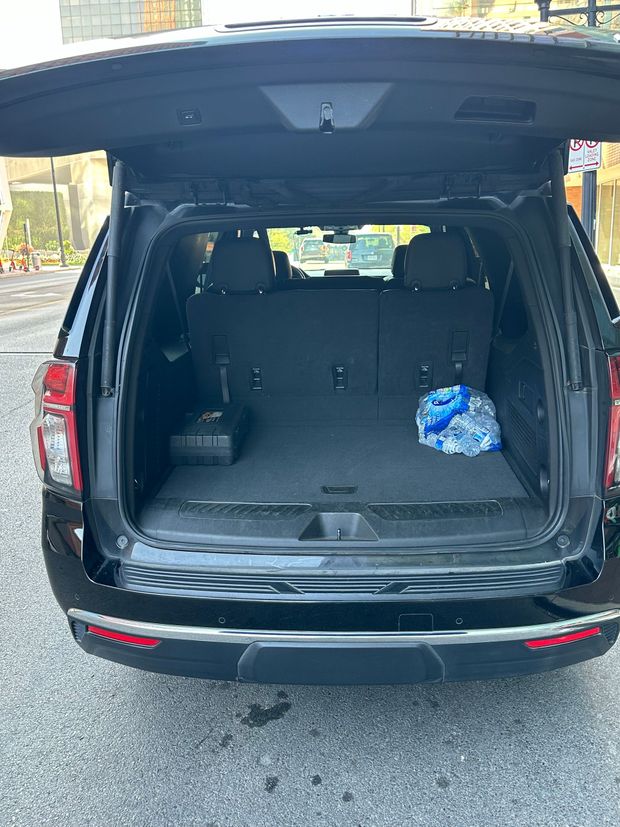 A man and a woman are sitting in a black car.