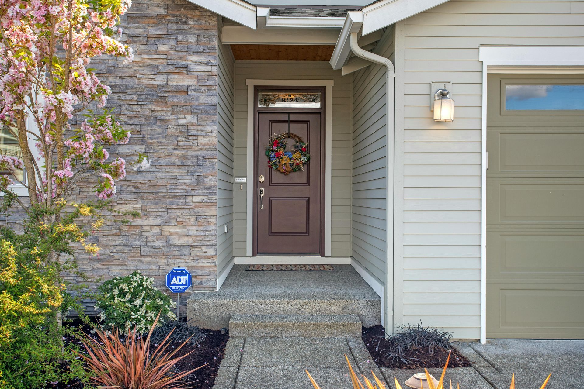 The front door of a house with a wreath on it.