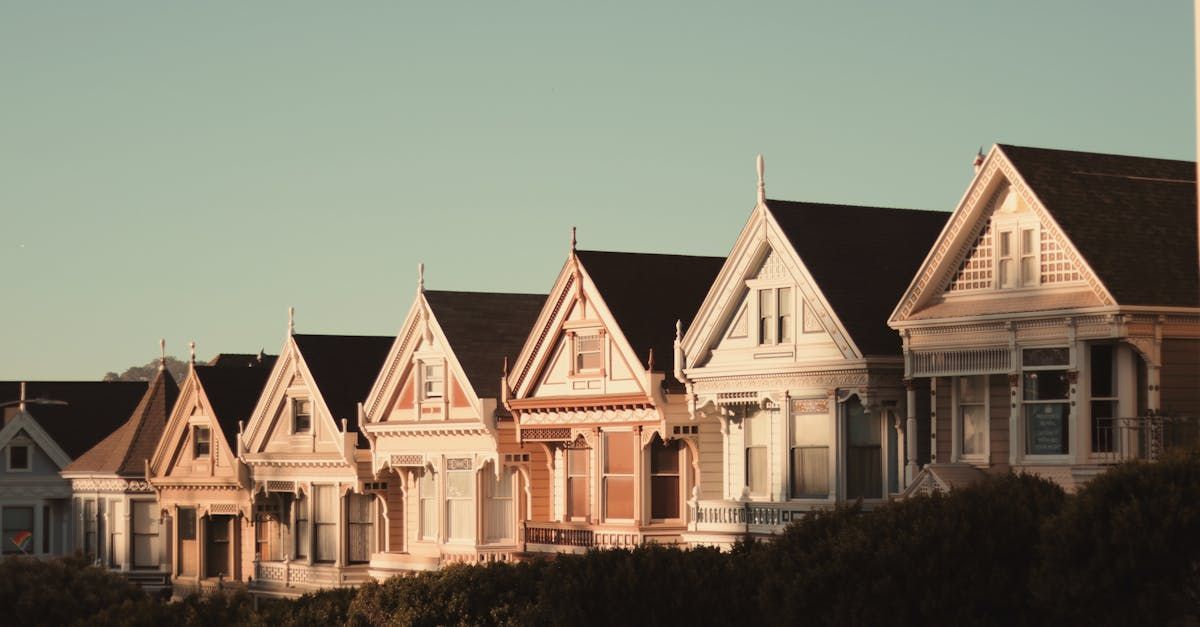 A row of houses with a blue sky in the background