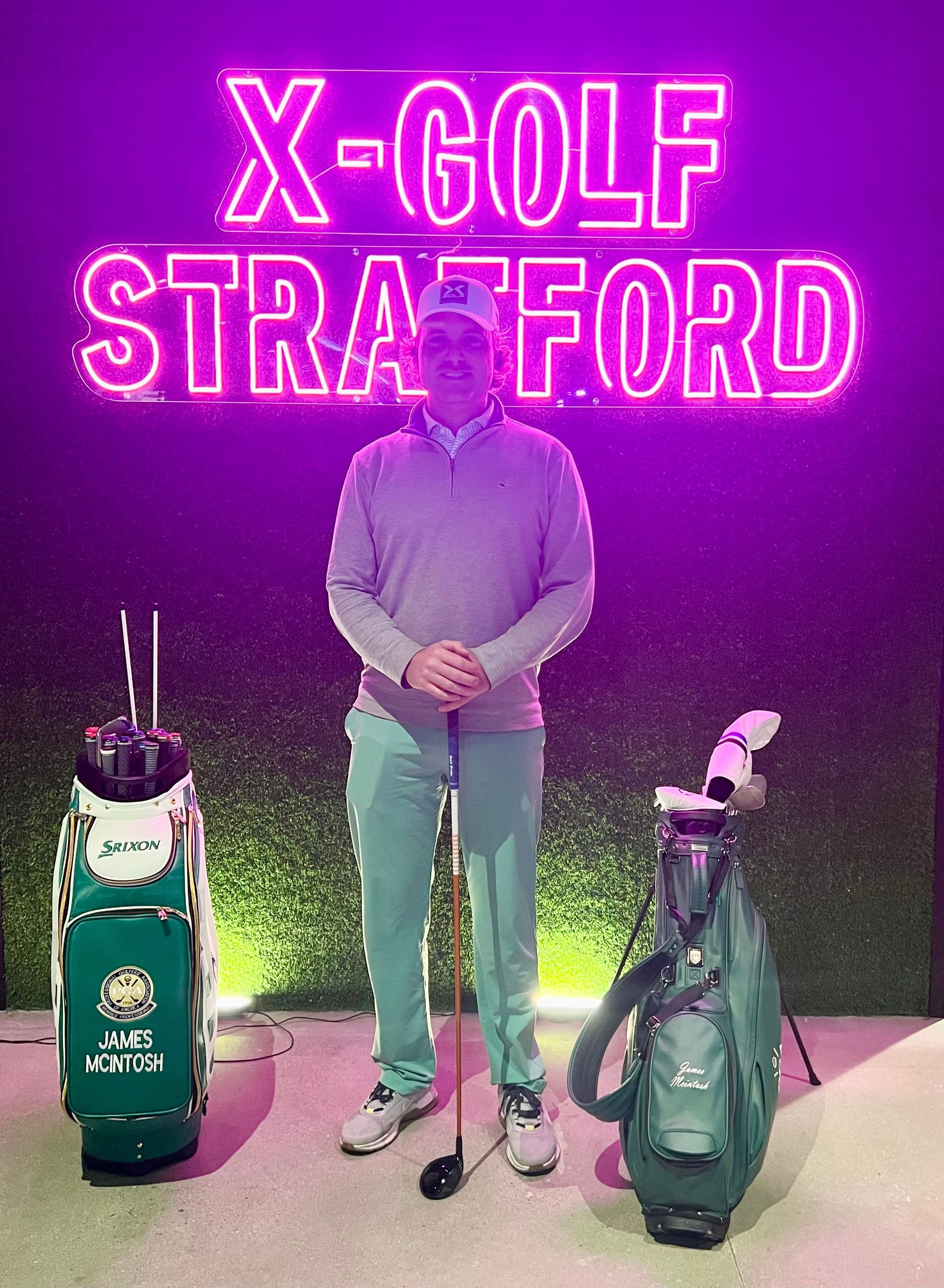 A man is standing in front of a neon sign that says x-golf stratford.