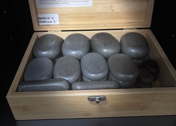 A wooden box filled with a variety of rocks