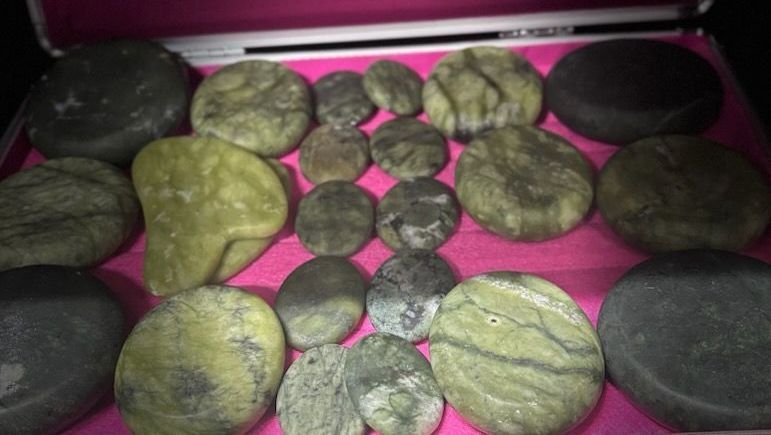 A bunch of rocks are sitting on a pink surface.