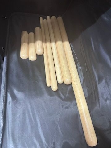 A bunch of wooden sticks are sitting on a table.