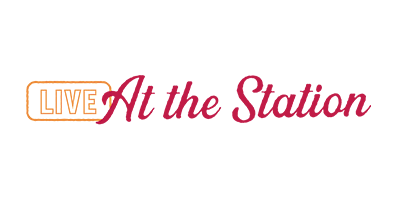 A logo for live at the station on a white background.