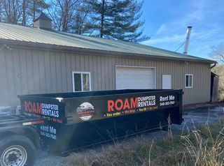 A 20 yard dumpster from Roam is parked in front of a home in Harrisonburg, VA. 