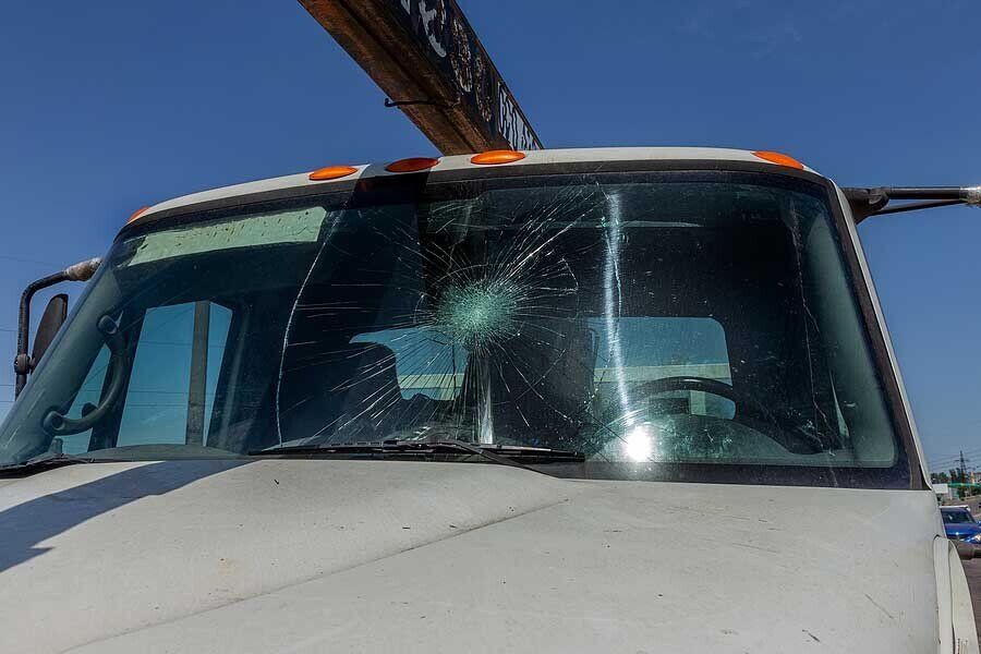 Broken car windshield. Web of radial cracks, crack on triple windshield.