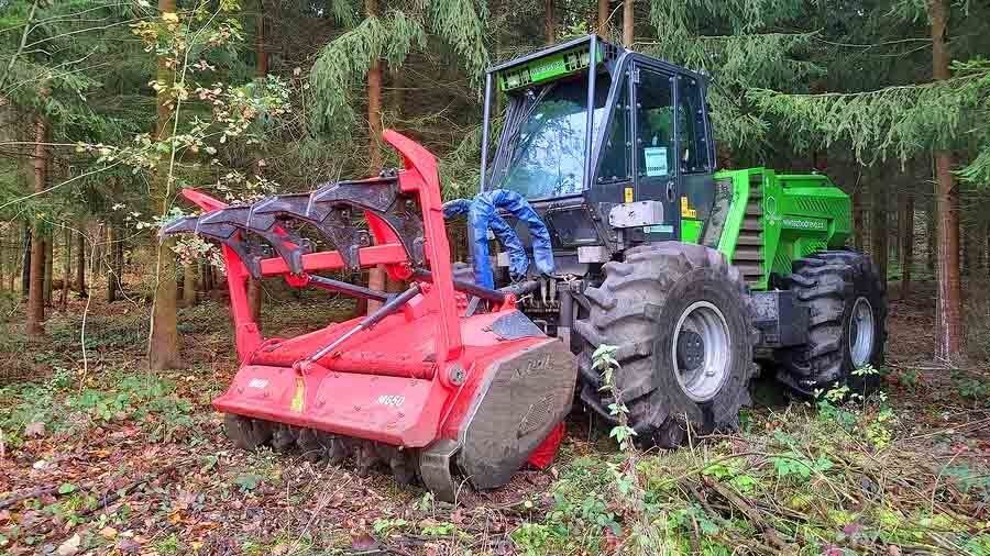 Pilsen / Czech Republic - October 31, 2019: Forestry tractor Merlo Tre Emme MM 350 X tool carrier with mulcher and stump cutter head working in forest.