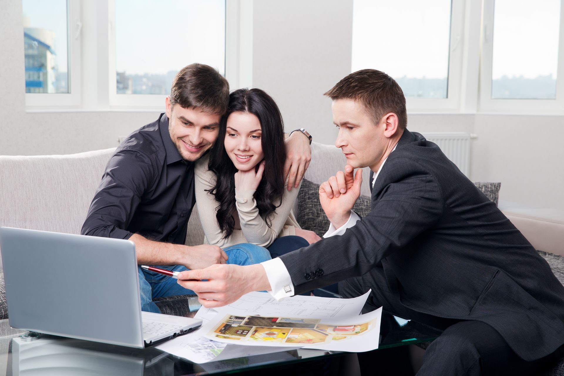 A couple is discussing interior design ideas with a professional designer for their home makeover.