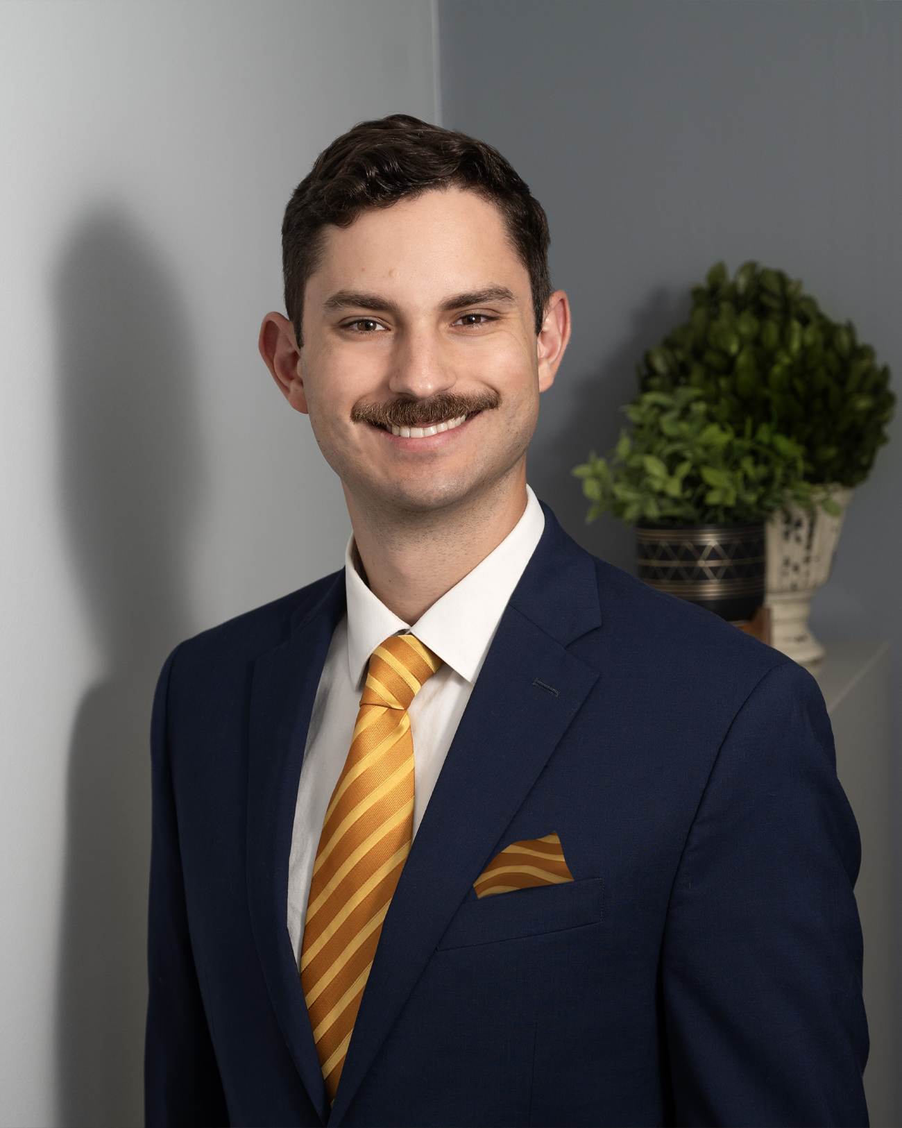 A man in a suit and tie is smiling for the camera.