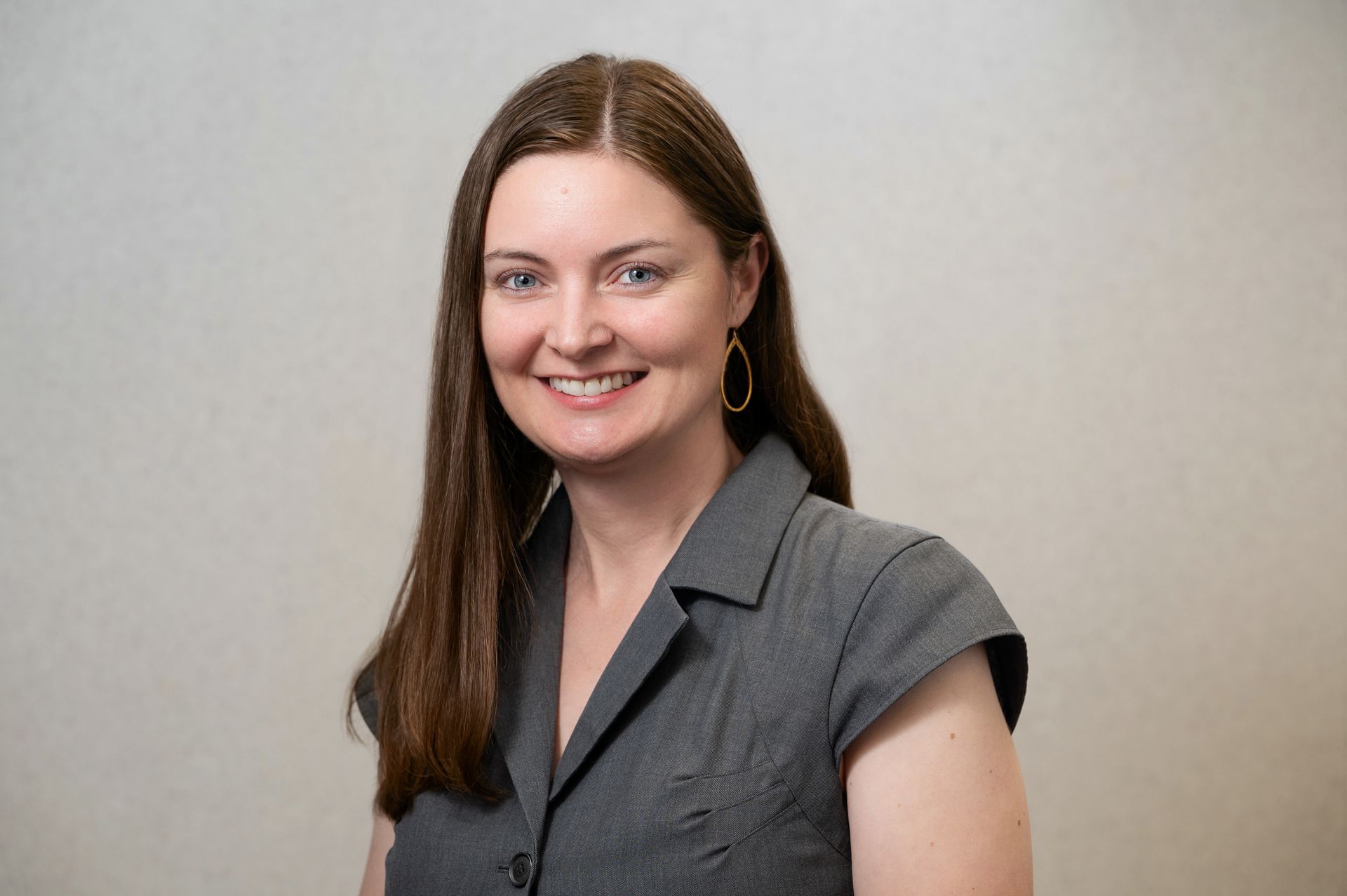 A woman is sitting at a desk with a pen in her hand.