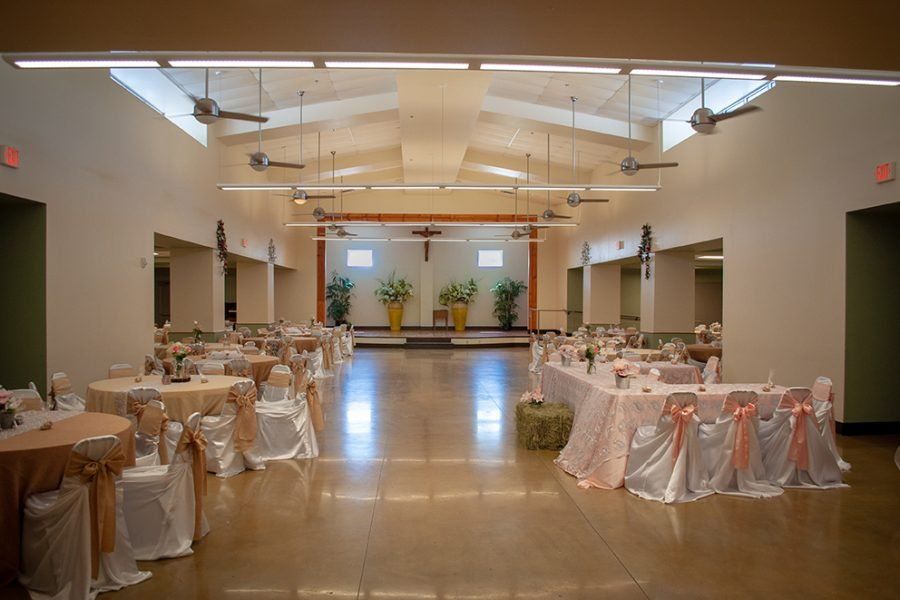 a large room with tables and chairs set up for a wedding reception