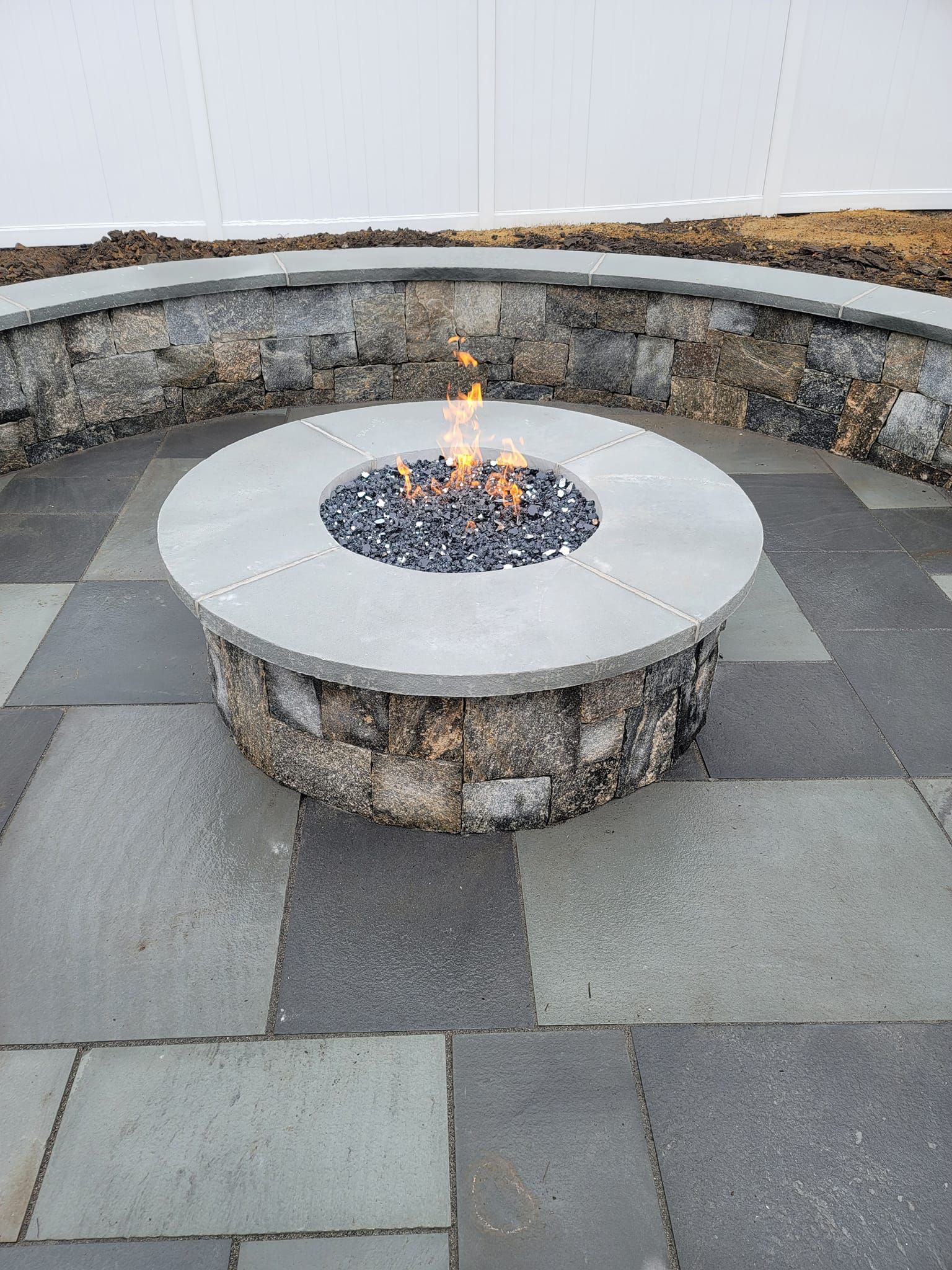 There is a fire pit in the middle of the patio.