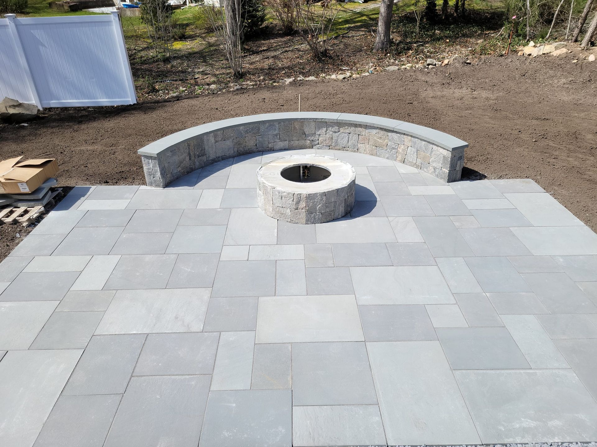 There is a fire pit in the middle of the patio.