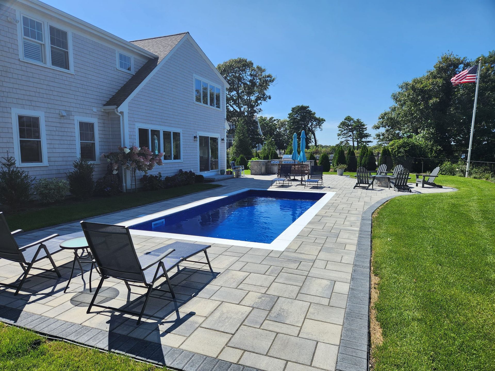 A large house with a large swimming pool in front of it