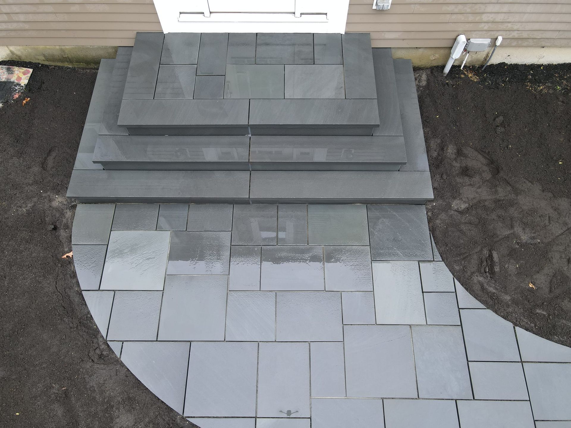 A stone walkway with steps leading up to a house