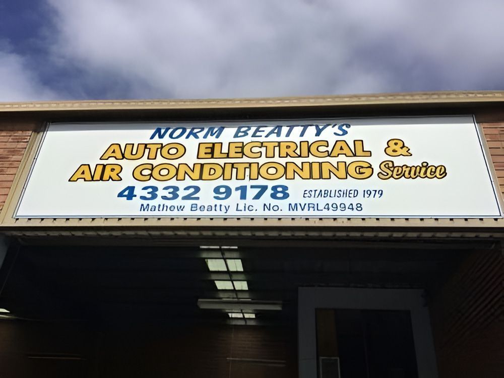 A Person Working on a Car Battery — Norm Beatty's Auto Electrical Service In Long Jetty, NSW