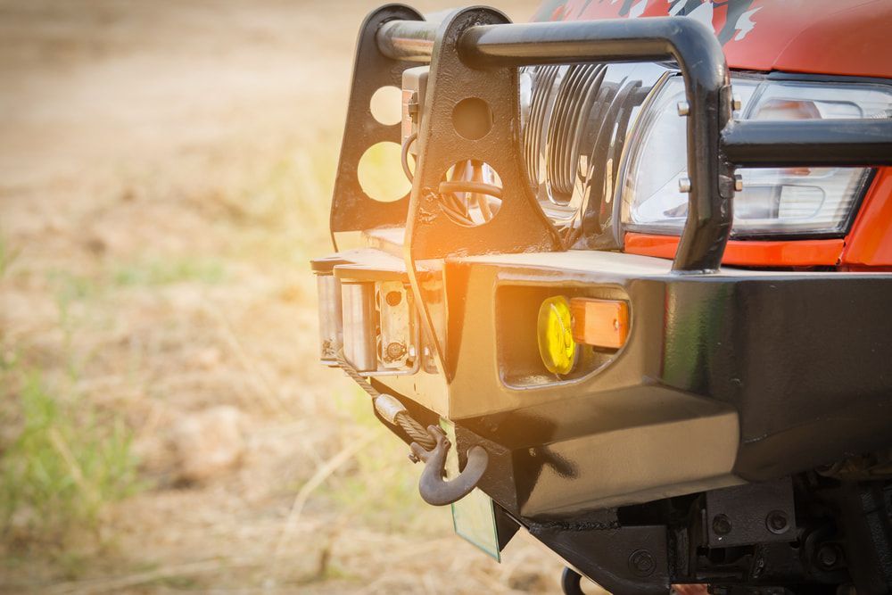 A Rugged Off-road Vehicle's Front Bumper With a Hook — Norm Beatty's Auto Electrical Service In Long Jetty, NSW