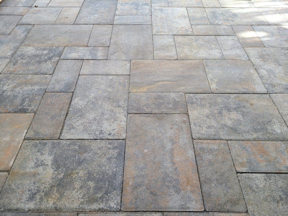 Stone patio with varying rectangular shapes in gray and brown tones.