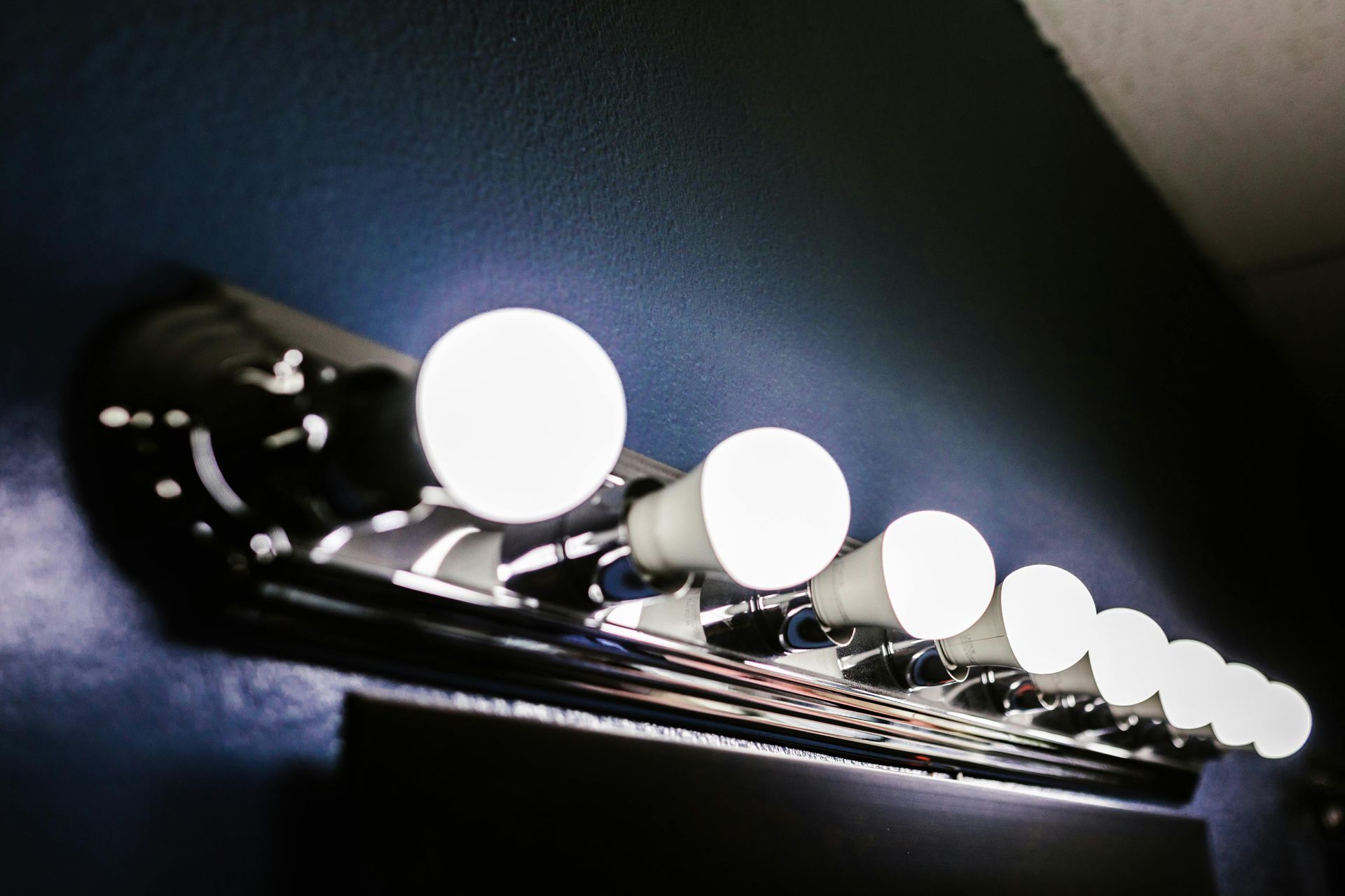 A row of light bulbs are lined up on a wall