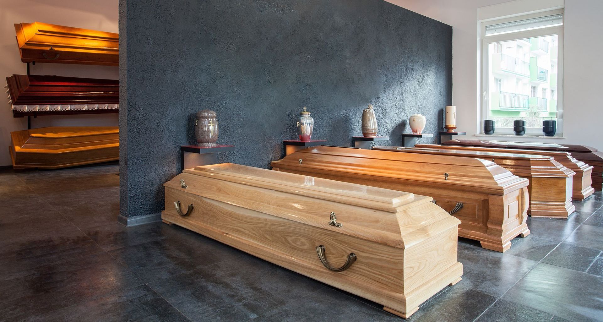 A row of wooden coffins are lined up in a room.