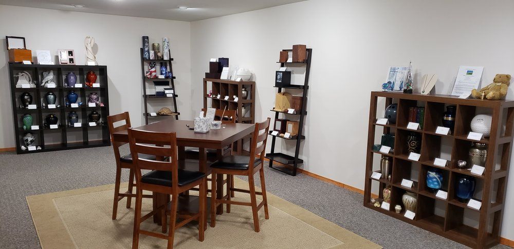 There is a table and chairs in the middle of the room.