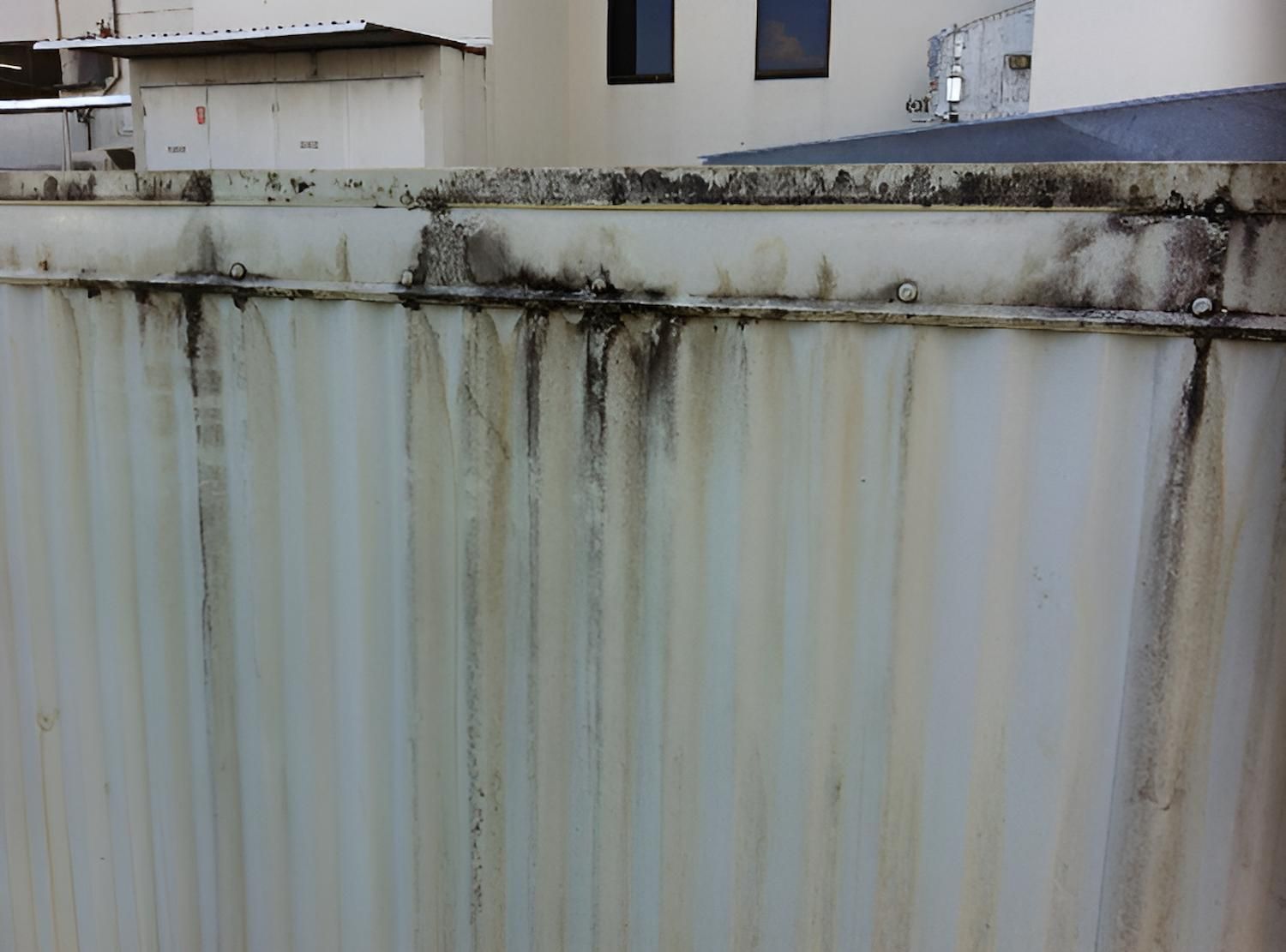 A White Fence With A Building In The Background — EcoPro Pressure Cleaning In Broadbeach Waters, QLD