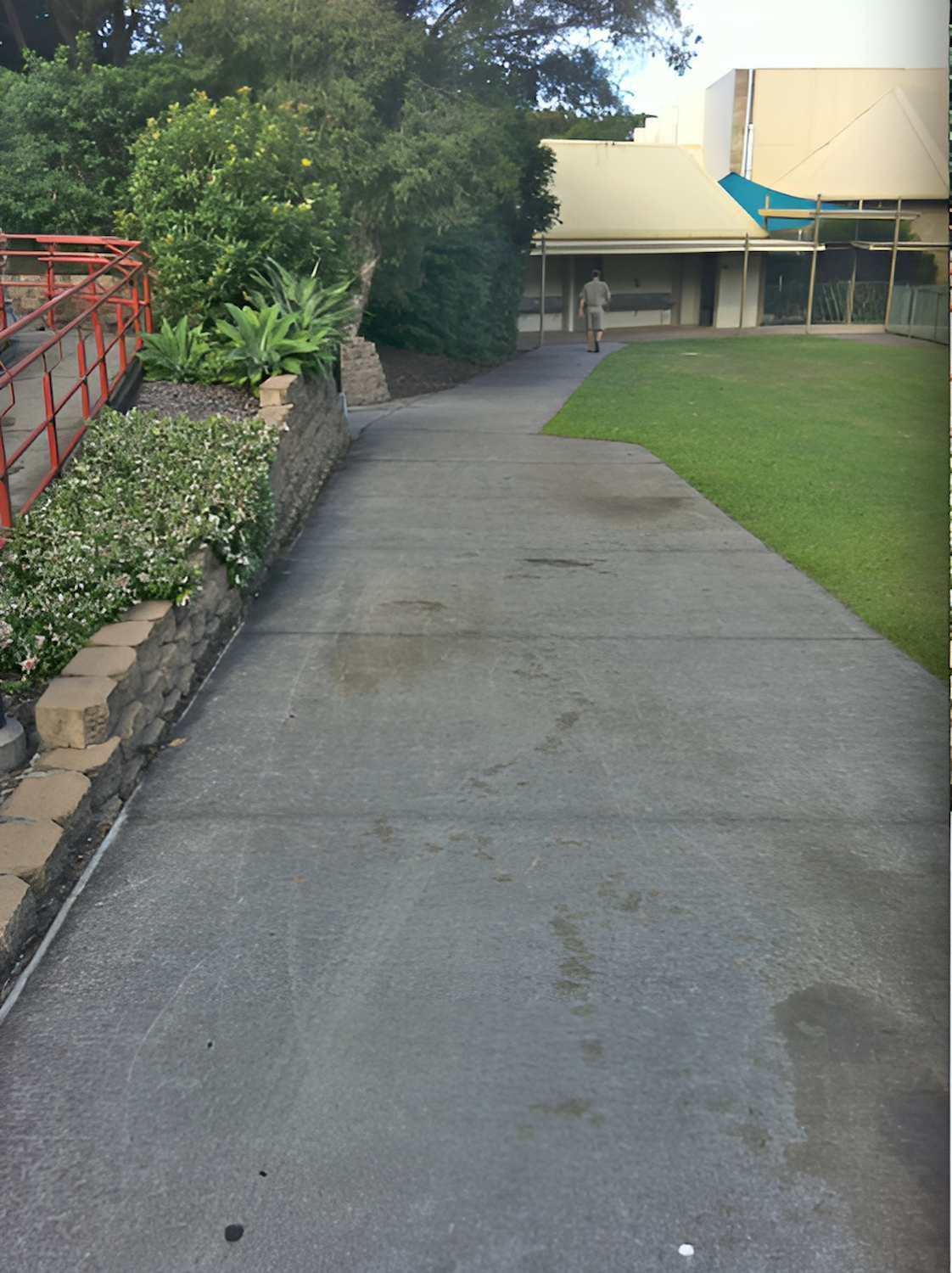 A Concrete Walkway Leading To A Large Building — EcoPro Pressure Cleaning In Broadbeach Waters, QLD