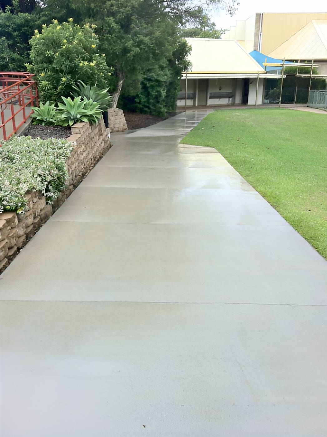 A Concrete Walkway Leading To A House With A Lush Green Yard — EcoPro Pressure Cleaning In Broadbeach Waters, QLD